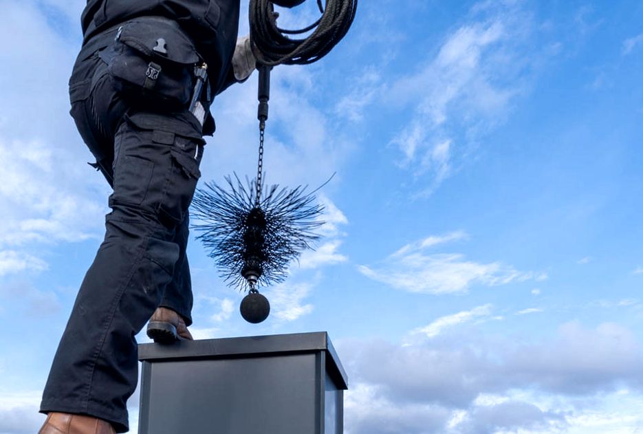 Weighted brush line lowered into a chimney chase